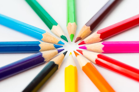 Colored pencils in a circle on the paper. Angle viewの写真素材