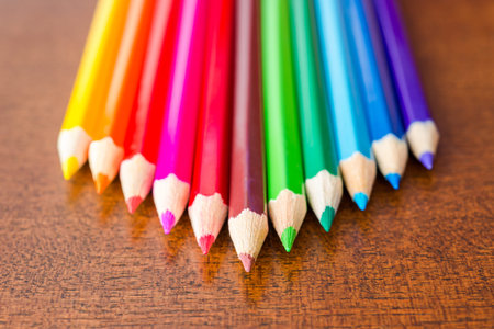 Pyramid of the colored pencils on wooden tableの写真素材