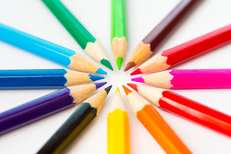 Colored pencils in a circle on the paper. Angle viewの写真素材