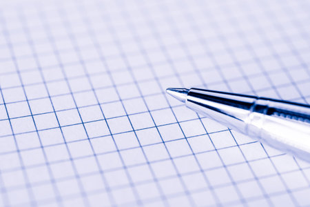 Pen on the paper closeup. Image in the blue toningの写真素材