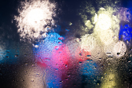 Rainy day in the city at night, view from the car windowの写真素材