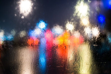 Rainy day in the city at night, view from the car windowの写真素材