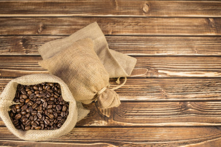 Sack coffee on a woody backgroundの写真素材