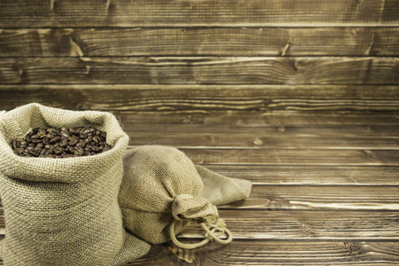Sack coffee on a woody backgroundの写真素材