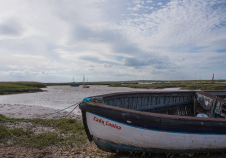 Boats moored at Burnham Staithes in North Norfolk.のeditorial素材