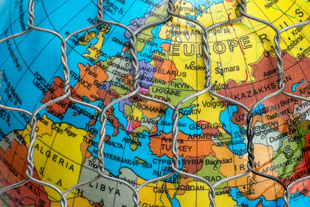 the global map behind a wire fence