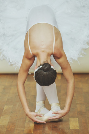 Closeup of ballerina while she is dancing the Swan Lake in studio.の写真素材