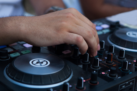 Operators hand on dj mixer controller.の写真素材