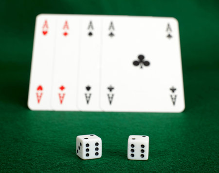 White dices and four aces on green table.Illegal gambling.