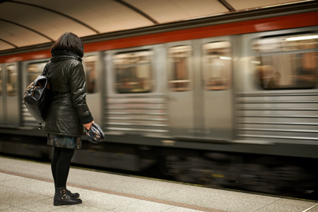 Woman waiting for the train in a metro station.の写真素材