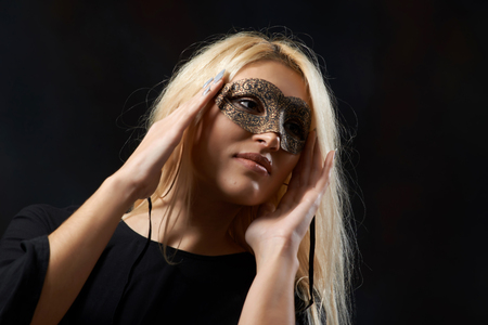 Beautiful young woman in a carnival mask.の写真素材