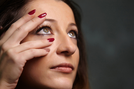 Portrait of beautiful woman with red nails.の写真素材