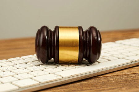 Judge gavel on computer keyboard.