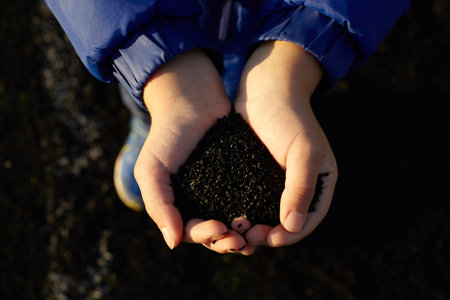 Kid's hands holdung black rubber.