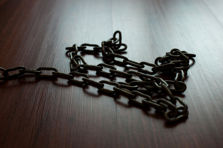 Chain standing on wooden floor.の写真素材