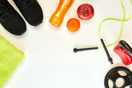 Fitness concept.Fruits, gym equipment and sport clothing on white background.Healthy lifeslile.の写真素材