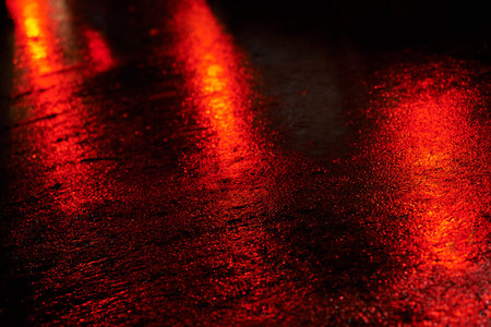 lights and shadows on wet road at rainy night.