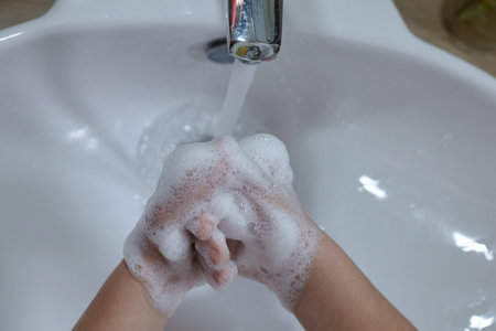 Washing hands rubbing with soap kid for coronavirus protection.
