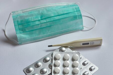 medical mask, thermometer and pills, against coronavirus.の写真素材