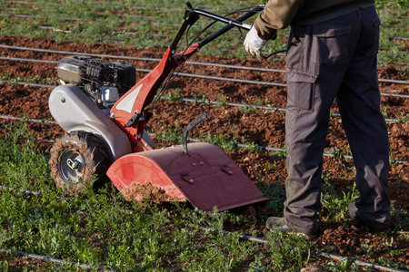 farmer works with a digging machine.