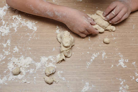 Kid you are playing and making dough.の写真素材