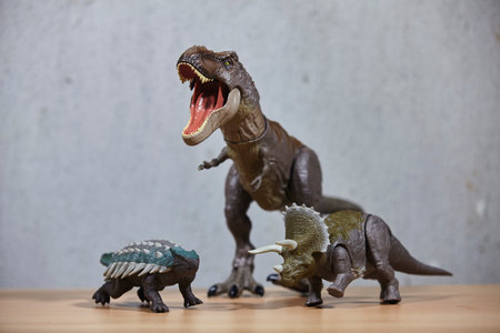 Dinosaur toys on wooden table.の写真素材