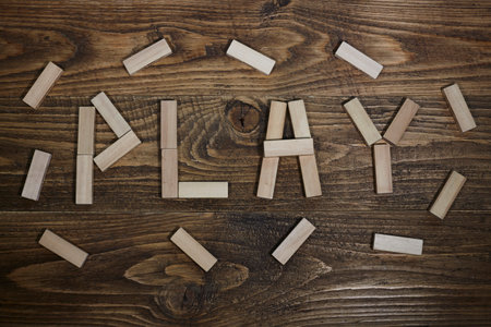 the word "play" written on wooden table. child toysの写真素材