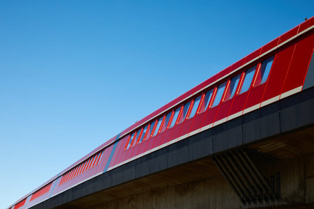 Railway station in abstract optics like an red line against the blue sky