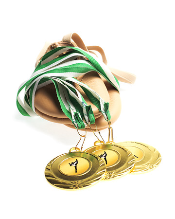 Gold Medals with gym shoes On white backgroundの写真素材