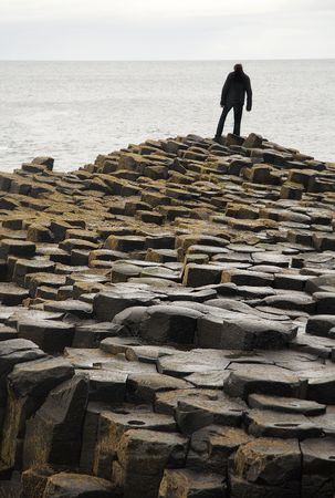 Lone figure on Giant's Causewayの写真素材