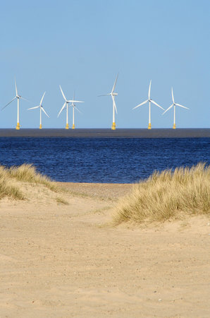 Beach and wind turbines at sea