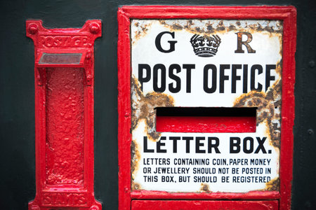 Vintage postbox weathered by age in English town