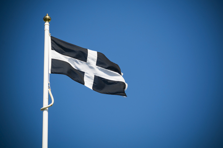 Cornwall flag flying against clear blue sky backgroundの写真素材