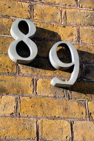 Number eighty nine on exterior wall in strong sunshine