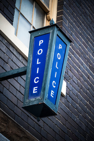 Police sign high on wall on exterior of police stationの写真素材