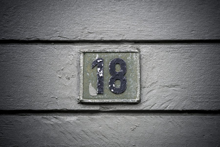 Number eighteen weathered sign on plank backgroundの写真素材