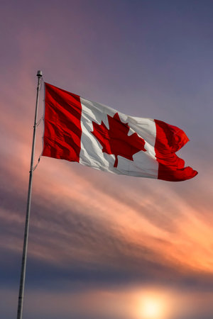 Flag of Canada blowing in the wind at sunsetの写真素材