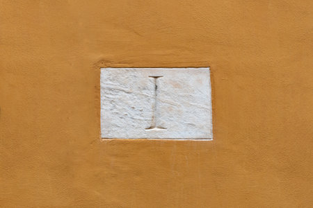 Number one door number carved into panel on plaster wallの写真素材