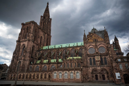 The gigantic Strasbourg cathedral looming up into a moody skyの写真素材