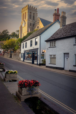Whitewashed buildings and church in Beer in Devon at duskの写真素材