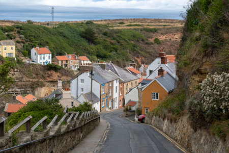 Steep road down into coastal village of Staithes in Yorkshireの写真素材