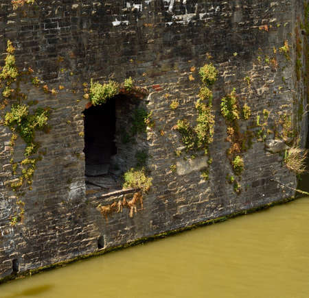 An entrance hole built into a medieval wall by the river in Bristol UKの写真素材