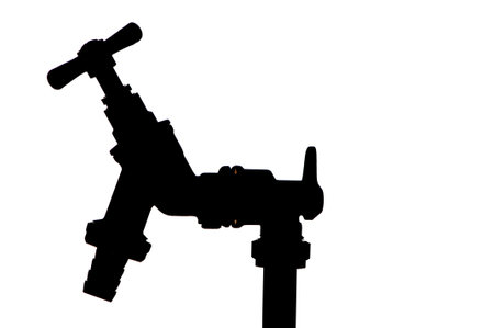 silhouette of an outside water tap fitted to standpipeの写真素材
