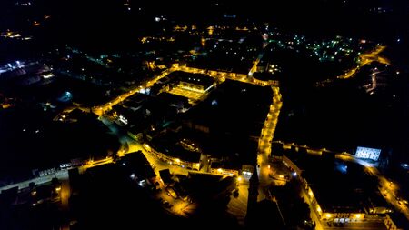 Drone view at night of a little town in Itayの写真素材