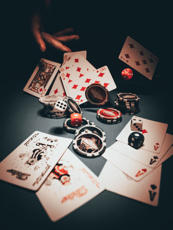 Playing cards and chips on a black background. Vintage-style tonedの写真素材