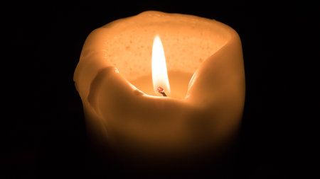 Candlelight on a black background. Close up image.の写真素材