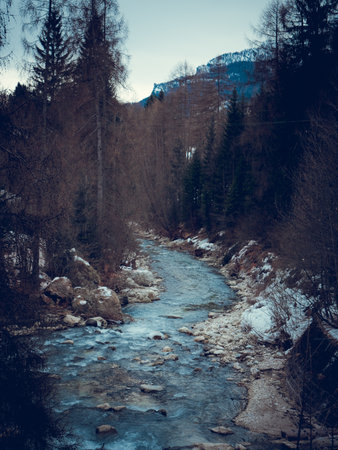 Mountain river in the winter forest. Filtered image processed vintage effect.の写真素材