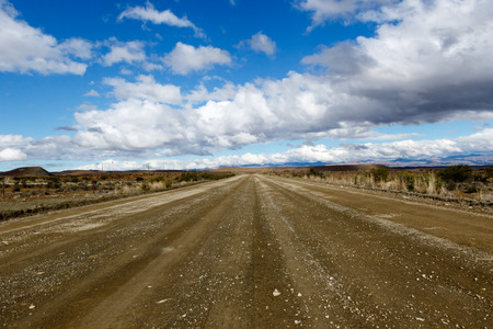 Dusty Road with Clouds - Prince Albert, South Africa is a small town in the Western Cape in South Africa. It is located on the southern edge of the Great Karoo, at the foot of the Swartberg mountains.の写真素材
