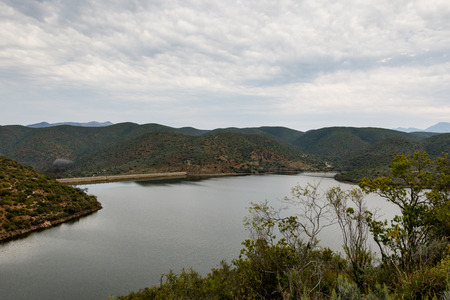 Cloudy and moody view from a bush of the dam at Calitzdorp.の写真素材