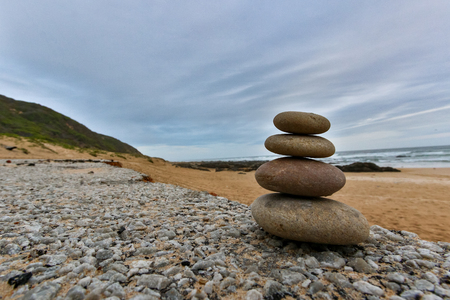 Karma stones standing on display on the beachの写真素材